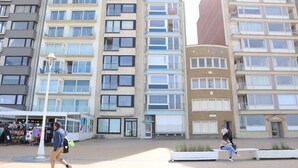 A modern building with multiple floors, large windows, and balconies. - Apartment Nieuwpoort near Sandy Beaches (Nieuwpoort)