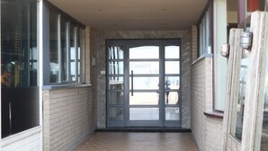 A narrow corridor with a glass door labeled "Casino A-B" and a brick wall. - Apartment in Nieuwpoort by the Sea Wall (Nieuwpoort)