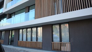 A modern building with large windows and a wooden slatted design on the upper floor.