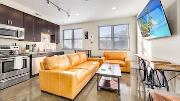 Signature Apartment | Living area | 65-inch Smart TV with digital channels, Netflix, Hulu