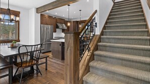A modern kitchen with a central island, stainless steel appliances, and wooden beams. - Family Retreat w/ Suncadia Pool Access (Cle Elum)