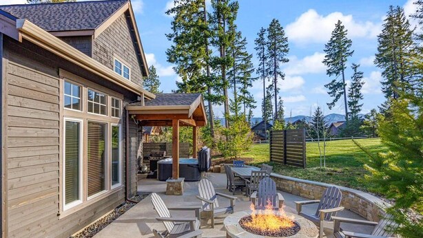 A wooden house with a patio area featuring a fire pit and outdoor seating. - Family Retreat w/ Suncadia Pool Access (Cle Elum)