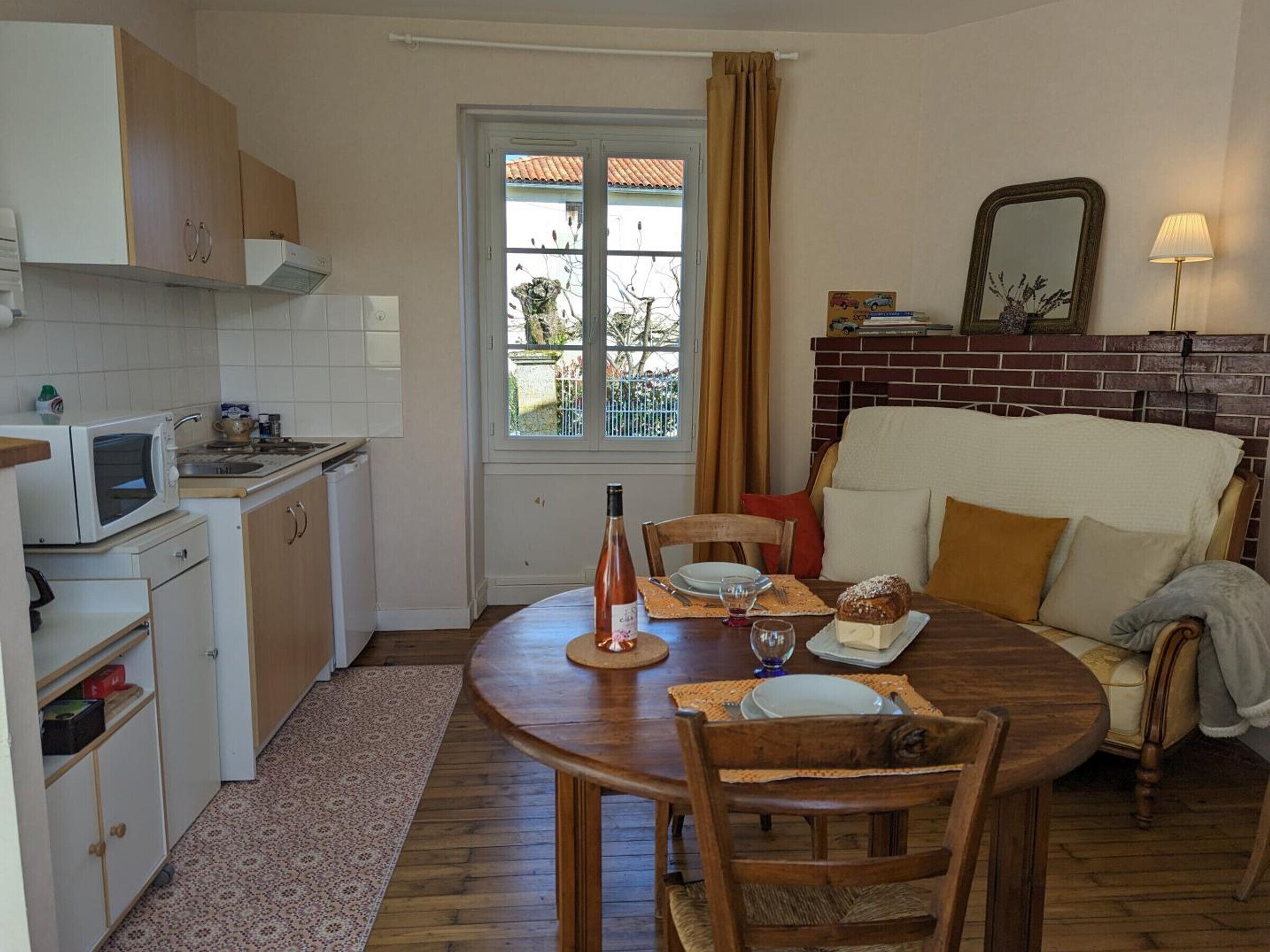 A compact living space with a kitchen, dining area, and a cozy seating area.
