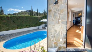 A swimming pool with stone tiles, a stone wall, and a view of a hillside. - EL SUEÑO : Fantastic house in Pals with private pool and wonderful views of the Medes Islands (Pals)