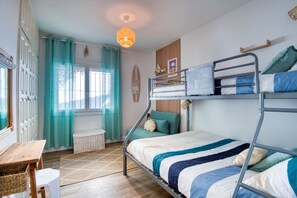 A bunk bed room with a window, curtains, a small table, and a hanging light fixture. - EL SUEÑO : Fantastic house in Pals with private pool and wonderful views of the Medes Islands (Pals)