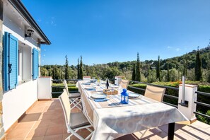 An outdoor dining area with a table set for four, overlooking a scenic landscape. - EL SUEÑO : Fantastic house in Pals with private pool and wonderful views of the Medes Islands (Pals)