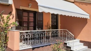 A building with a balcony, a white awning, and a metal railing. - La Casa di Volpe (Corfu)