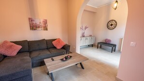 A living room with a sofa, coffee table, and a cabinet. - La Casa di Volpe (Corfu)