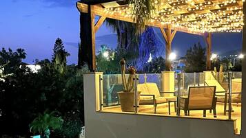 Relax on the outdoor terrace, surrounded by lush gardens and a serene atmosphere.