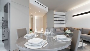 A modern dining area with a round table set for four, surrounded by chairs. - Italianway - Transiti 20 (Milan)