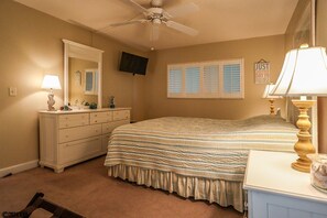 Relax in this serene bedroom with a single bed, dresser, and television.