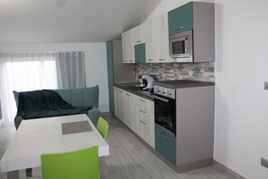 Condo Deluxe | Bếp riêng | Dụng cụ pha espresso, ấm điện, bàn ăn 