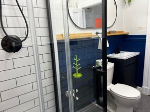 Shower, hair dryer, towels, toilet paper