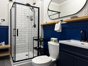 Shower, hair dryer, towels, toilet paper