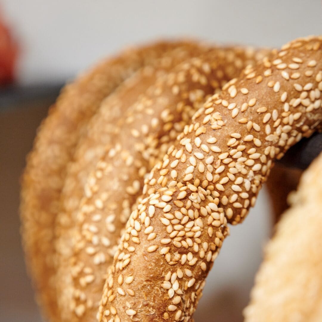 A close-up of a sesame seed-covered bread roll.