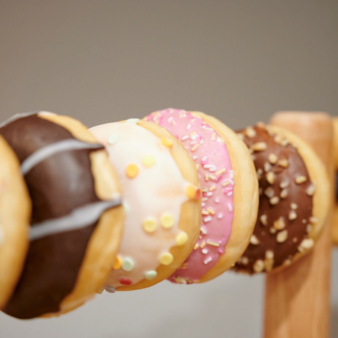 A close-up of a chocolate-covered doughnut with sprinkles.
