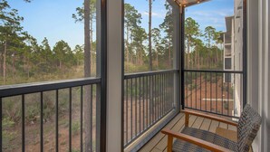 A balcony with a view of a forest. - 1BR/1BA, Deck, Beach Access! + Free Attraction Tickets! (Santa Rosa Beach)
