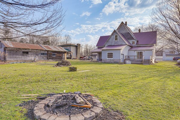 A large house with a sloped roof and a fenced yard.