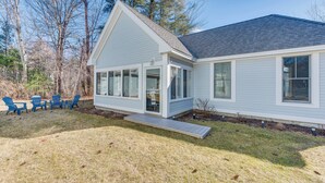 A modern house with a covered porch, a small deck, and a lawn with outdoor furniture. - Cozy Wells Cottage w/ Pool Access: 1 Mi to Beach! (Wells)