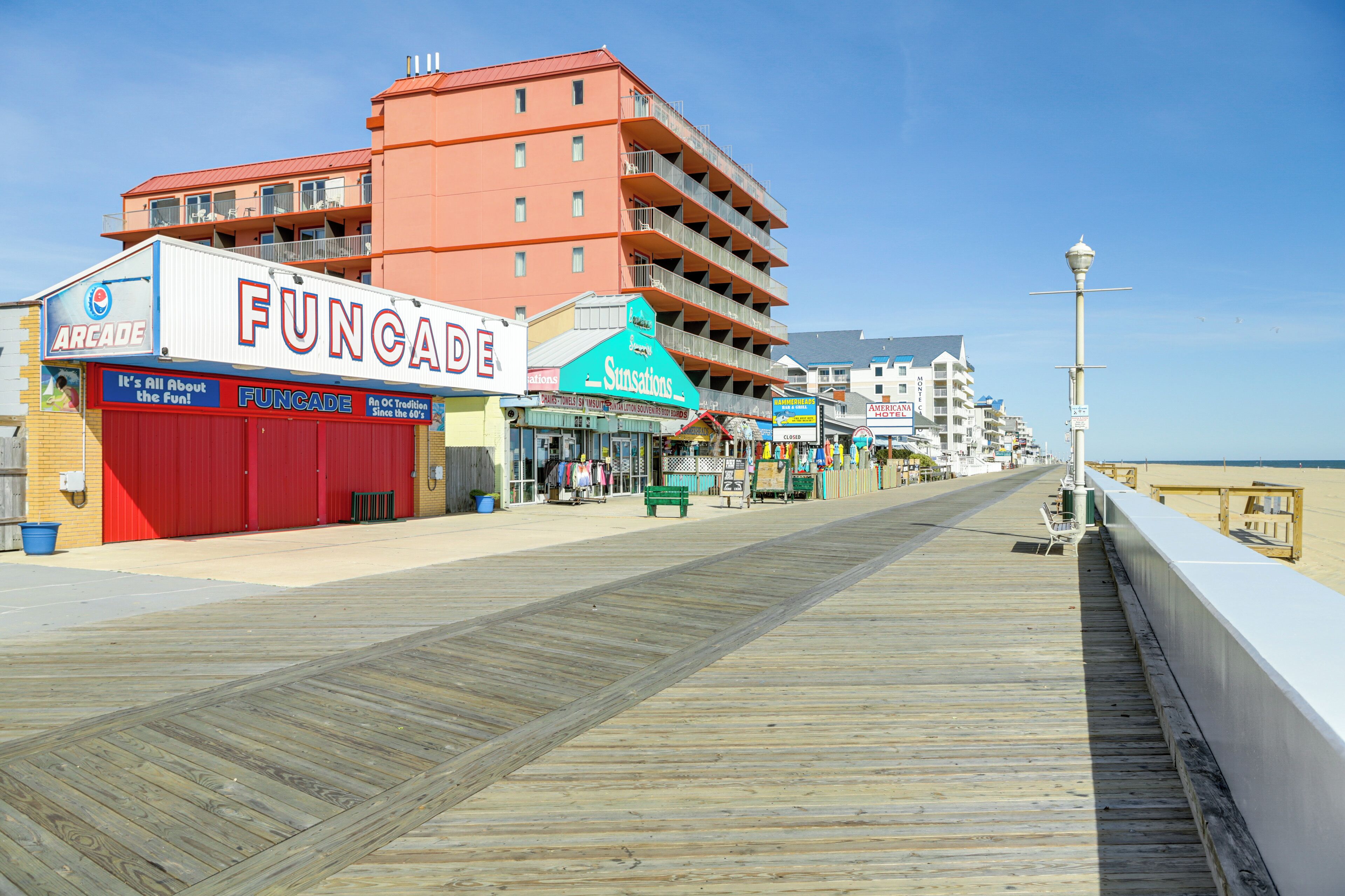 A boardwalk with a Funchade arcade and a Suncations hotel.