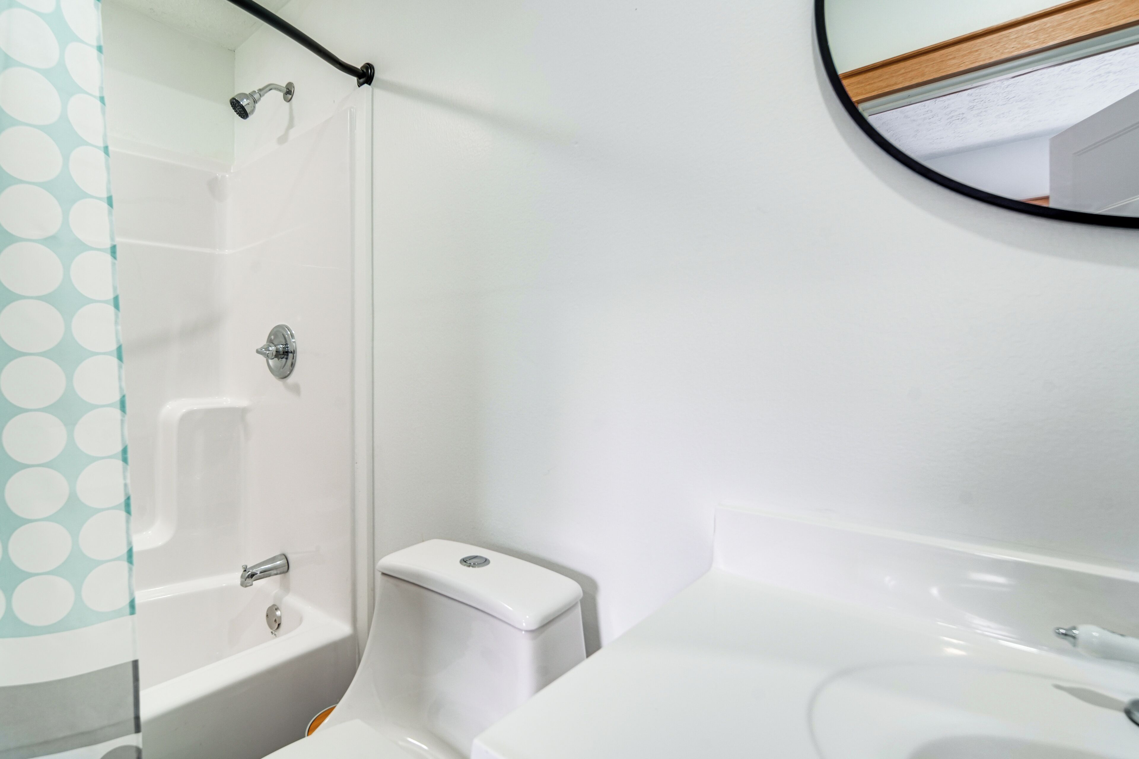 A bathroom with a bathtub, toilet, and sink.