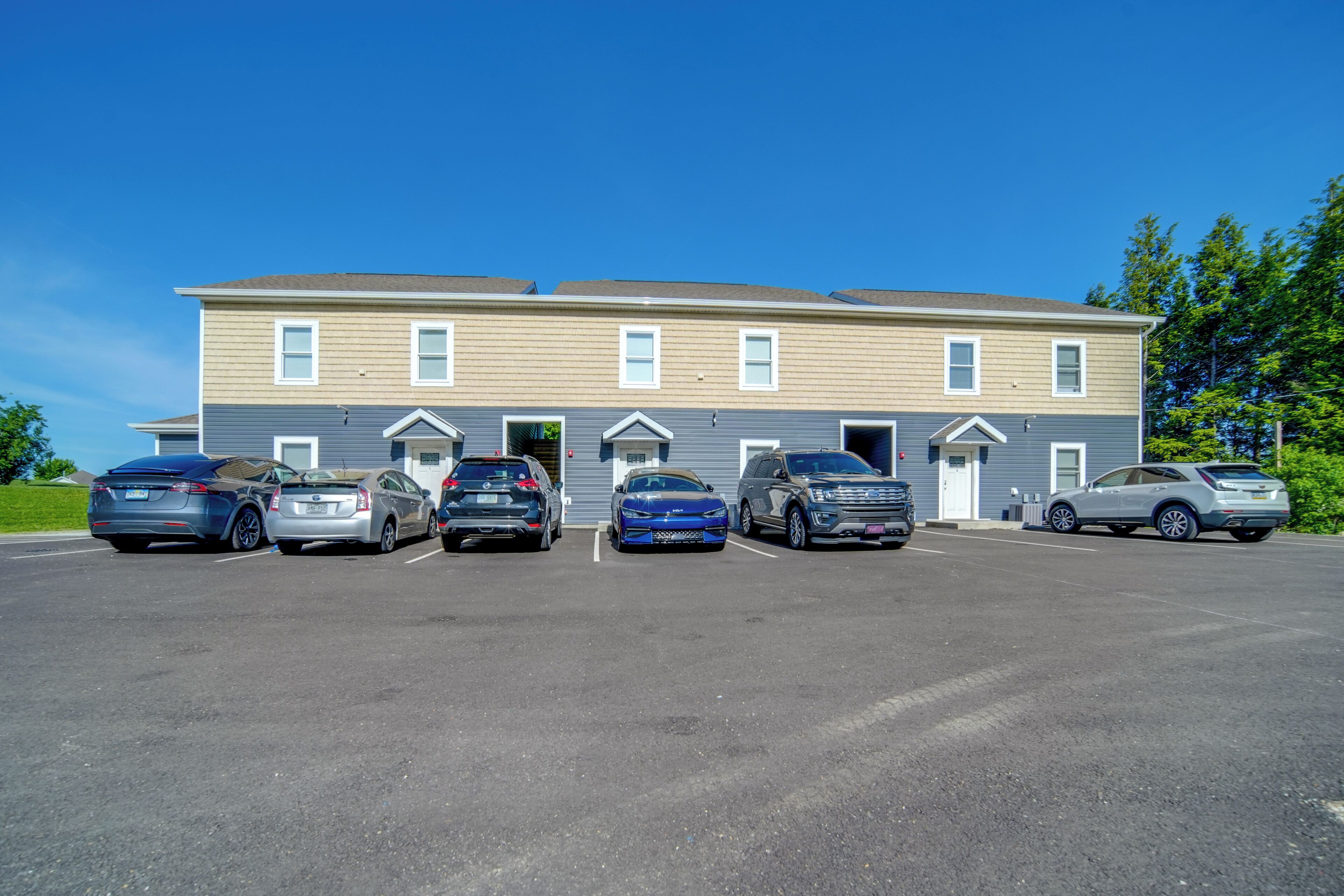 A multi-story building with a parking lot.