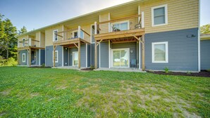 A multi-story residential building with a covered patio area and a well-maintained lawn. - 4 Mi to Lake Erie: Condo w/ Golf Course Views! (Erie)