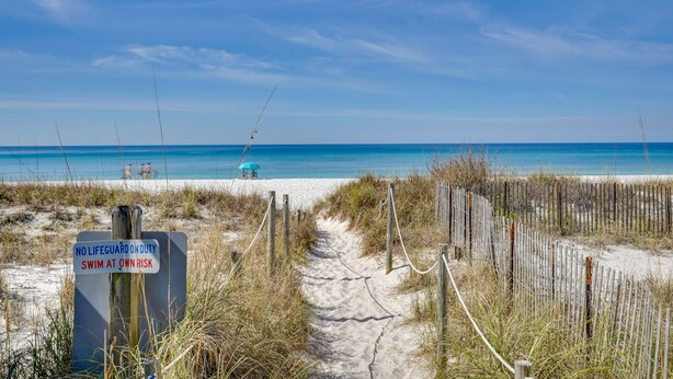 A beach path with a sign warning of no lifeguard on duty and advising to swim at own risk. - Panama City Beach Home: Steps to the Ocean! (Panama City Beach)