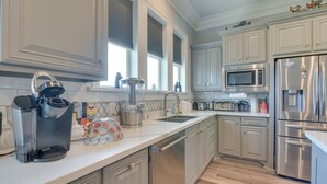 A modern kitchen with stainless steel appliances, a dishwasher, and a microwave.