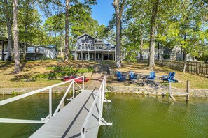A lakeside property with a dock, a house, and outdoor seating. - Hot Springs Lakefront Home w/ Dock & Water Views! (Hot Springs)