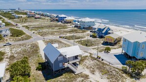 A coastal area with beach houses, a road, and a view of the ocean. - Pet Friendly | Gulf Views | Golf Cart | Deeded Beach Access (Gulf Shores)