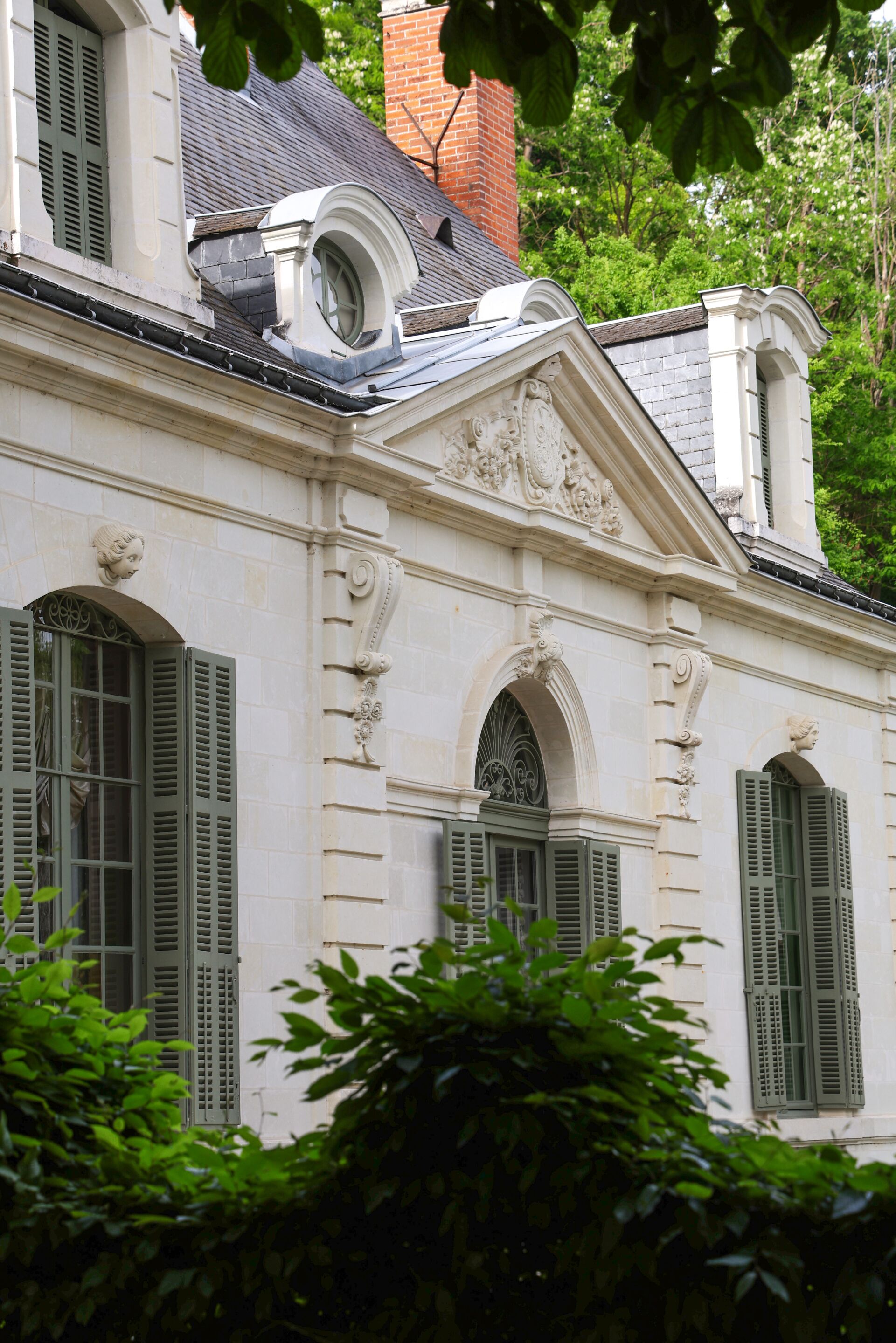 A historic building with ornate architectural details, including a prominent arched window and decorative moldings.