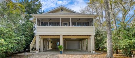 A two-story house with a covered garage and a balcony.