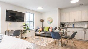 A modern apartment with a living area, dining space, and kitchen. - Vibrant Studio KING ! Free Parking ! 30 min to NYC (Orange)