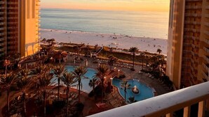 A resort with a pool area, beach view, and multiple buildings. - Beachfront Resort Condo w/HUGE Lagoona Pool (Panama City Beach)