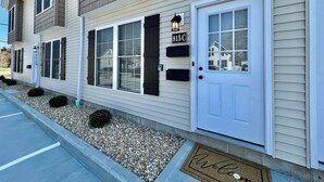 A two-story building with a white door and a mailbox labeled "815 C".