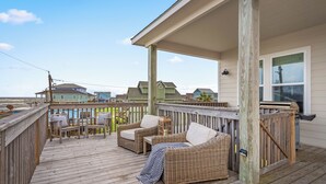 A wooden deck with wicker furniture and a covered area. - Cold Pass Cottage - 3BR, panoramic views (Freeport)