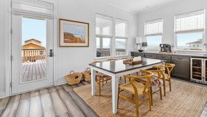 A modern kitchen with a dining area, large windows, and a view of the outside. - Cold Pass Cottage - 3BR, panoramic views (Freeport)