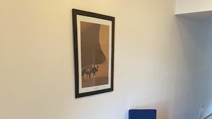 A small room with a wooden floor, a table, and two blue chairs. - 1 Bed Flat - Sleeps 2 - Pets - Smoking on Terrace (Prague)