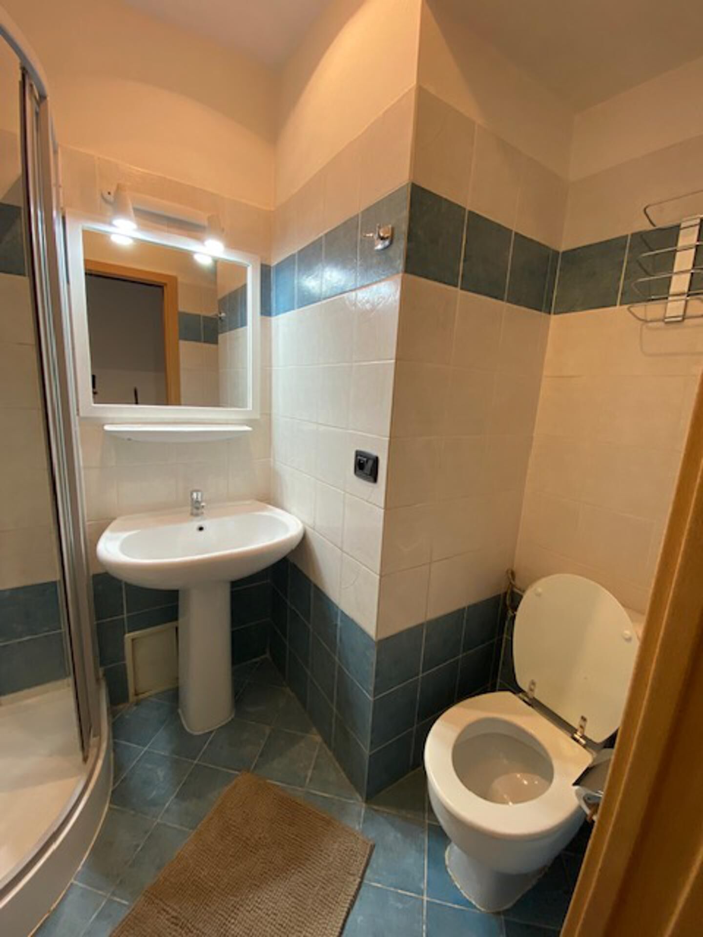 A bathroom with a sink, toilet, and shower.