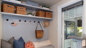A room with a bench, baskets, and a sign reading "Lake House Inn."