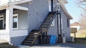 A two-story house with a front porch, a staircase, and a garage. - COZY PRIVATE 3 BEDROOM APARTMENT HIGH END SLEEP 6 (Roanoke)