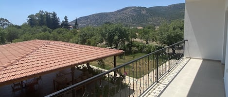 A balcony with a tiled floor and a metal railing.