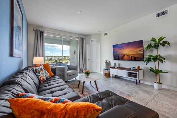 Ein modernes Wohnzimmer mit einer Couch, einem Couchtisch und einem Gemälde an der Wand.