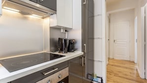 A modern kitchen with a built-in stove, a coffee maker, and a microwave. - Splendid Apartment in the Very Center Paris / Great for Olympic Games 2024 (Paris)