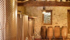 A room with stone walls, metal tanks, and wooden vases. - Villa 'Casa Voglietti' with Private Pool, Wi-Fi and Air Conditioning (Murisengo)
