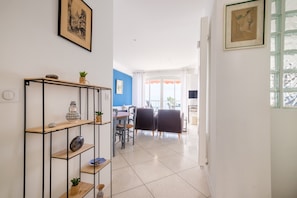 A modern living room with a dining area, a staircase, and a view of the outside. - Apartment Angelina with Sea View, Private Terrace and Wi-Fi (cagnes-sur-mer)