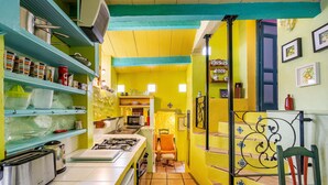 A kitchen with a stove, microwave, and various kitchenware.