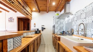 A narrow kitchen with wooden cabinets, a large sink, and patterned backsplash tiles. - Apartment "Albiez Montrond" with Mountain View, Balcony and Wi-Fi (Albiez-Montrond)
