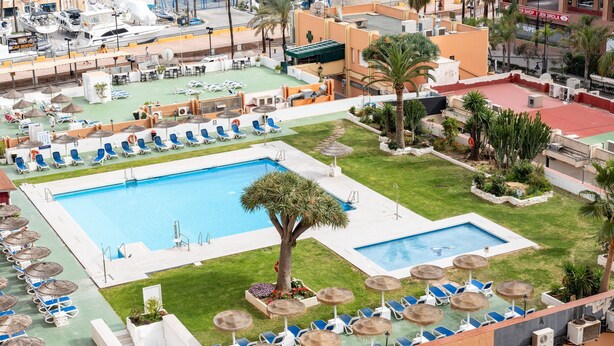 A rooftop pool area with multiple swimming pools, lounge chairs, and umbrellas. - Apartment In A Hotel 'Marina View, Sunny One Bedroom Pyr' with Shared Pool and Air Conditioning (Fuengirola)